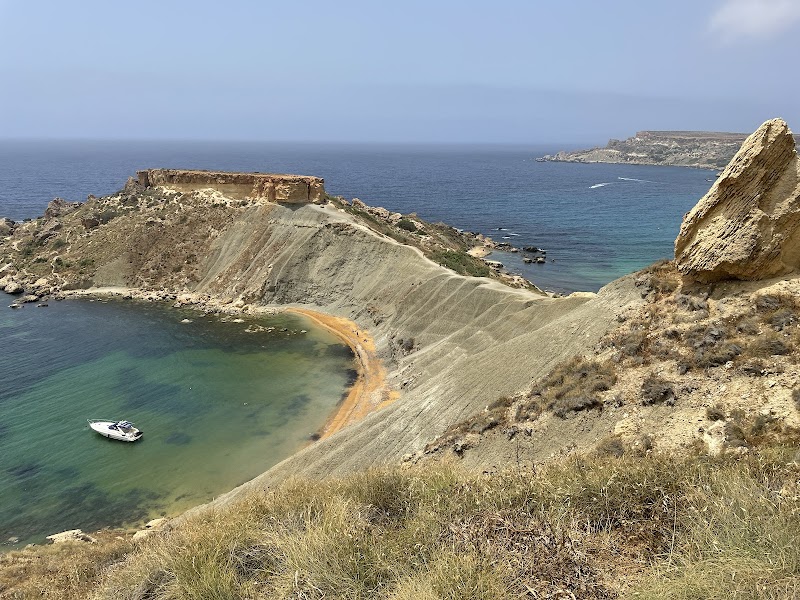 Serene Sands of Ġnejna Bay surrounding landscape